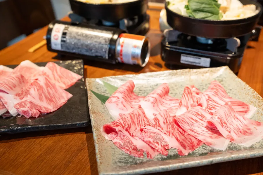 Thin slices of Wagyu fanned over a plate